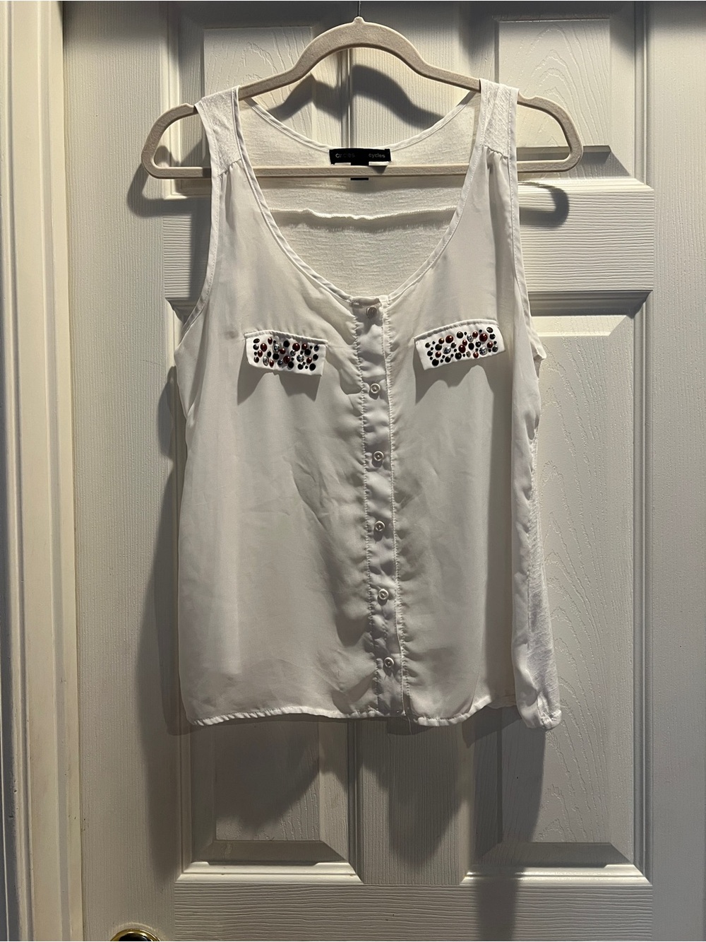 Sleeveless White Button-Front Blouse with Embellished Pocket Flaps